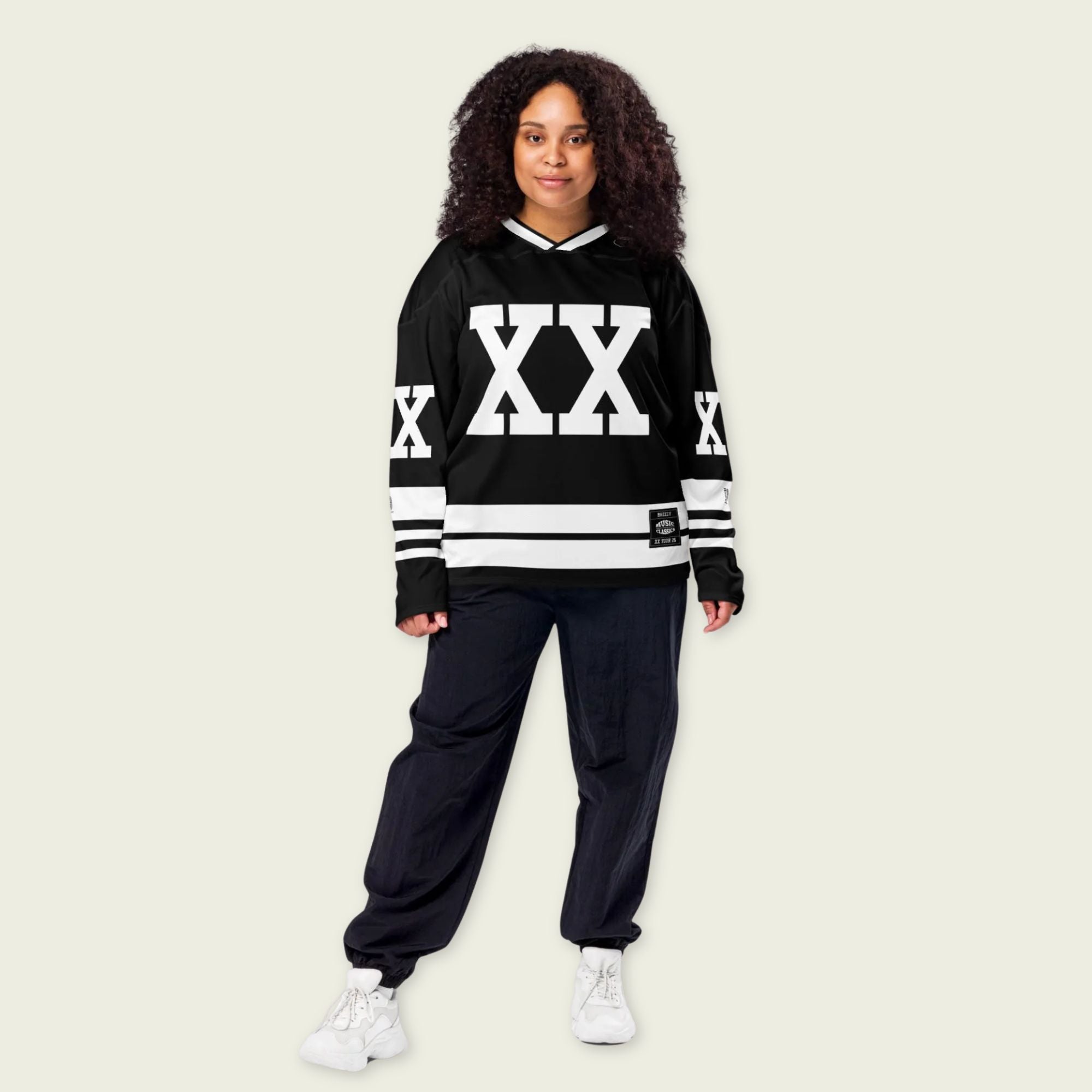 A Chris Brown Breezy Bowl Tour black and white hockey jersey with white lines showing the name Breezy on black on the back and XX on the front and back in white also. 