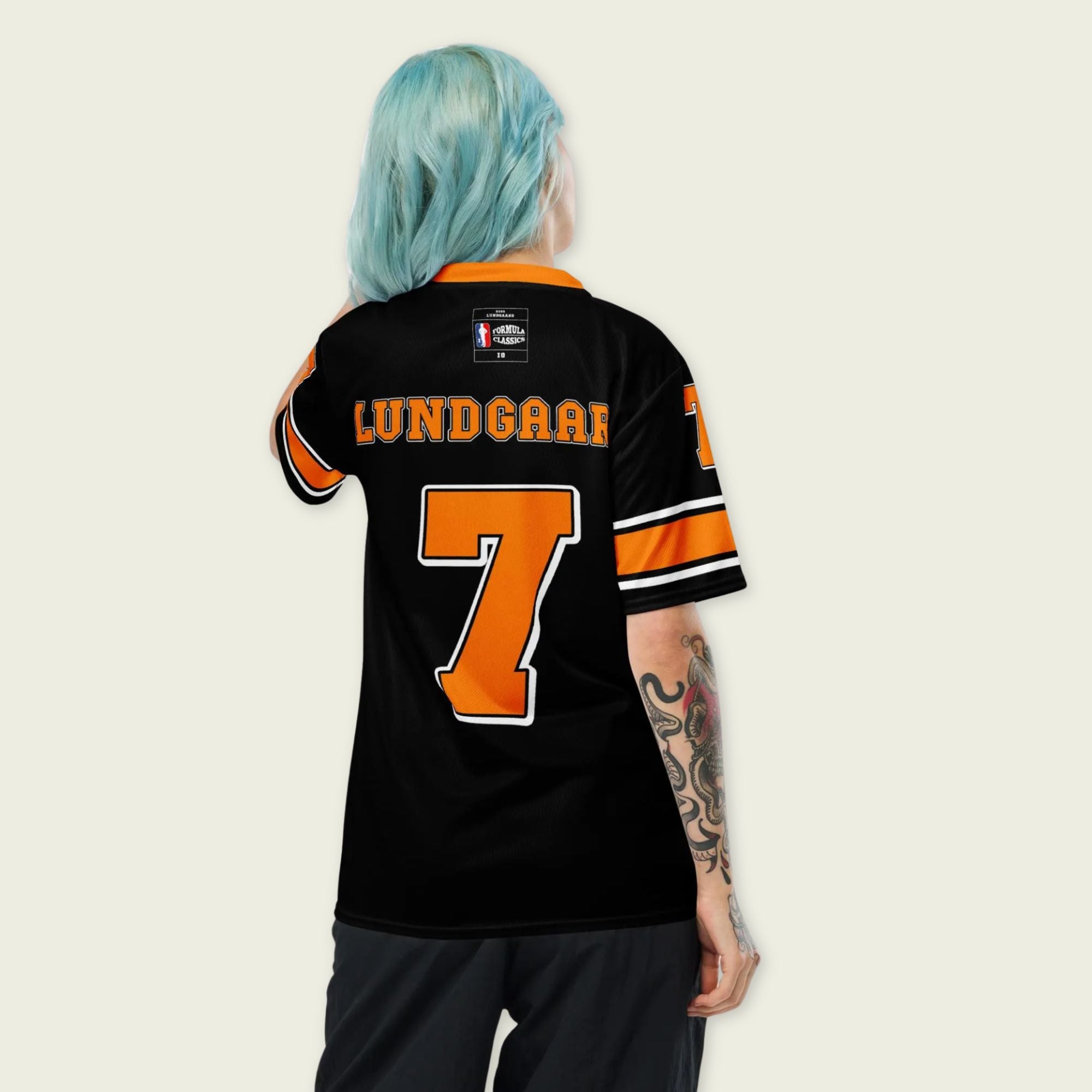 A black and orange football jersey with Christian Lundgaard Arrow McLaren Indycar racing number 7 in orange.