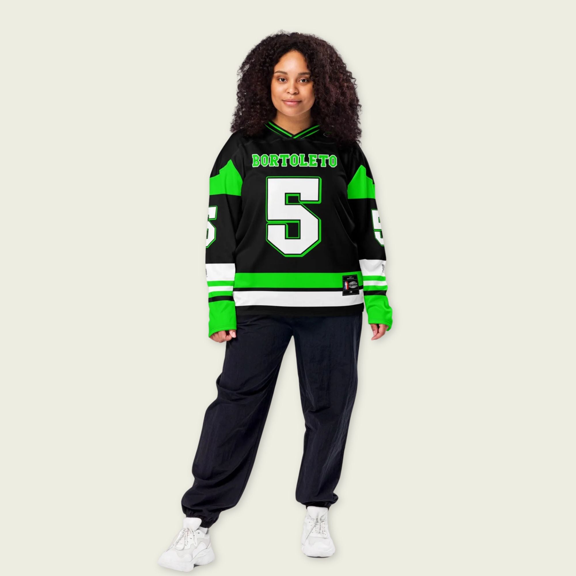 A green and black hockey jersey with Gabriel Bortoleto's Kick Stake F1 racing number 5 in green on the front and back. It has the name Gabriel Bortoleto on the back and front in green as well.