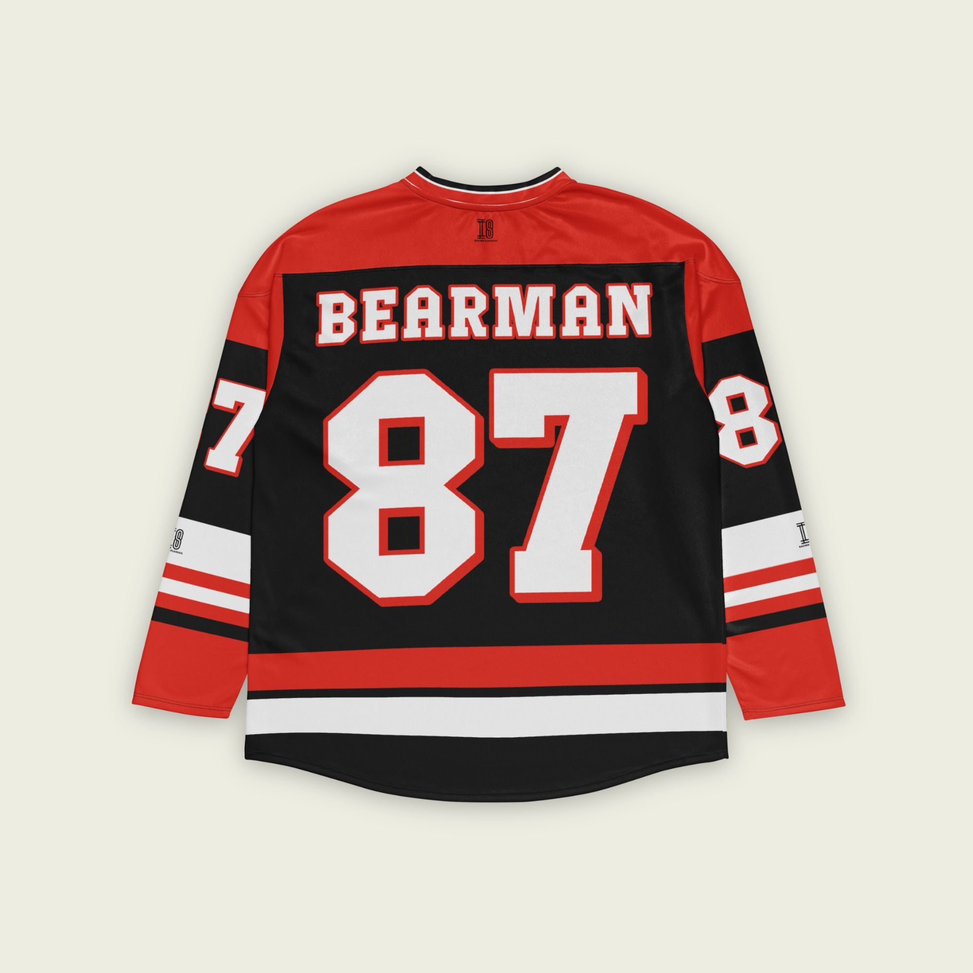 A red and black hockey jersey with Oliver Bearman's Haas F1 racing number 87 on the front and back in white, also the name Bearman is on the back and front in White.