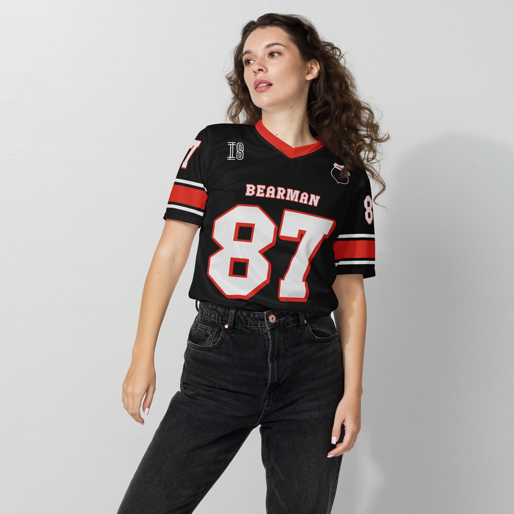 A black and red football jersey with Oliver Bearman's Haas F1 Racing number 87 in white on the front and back.