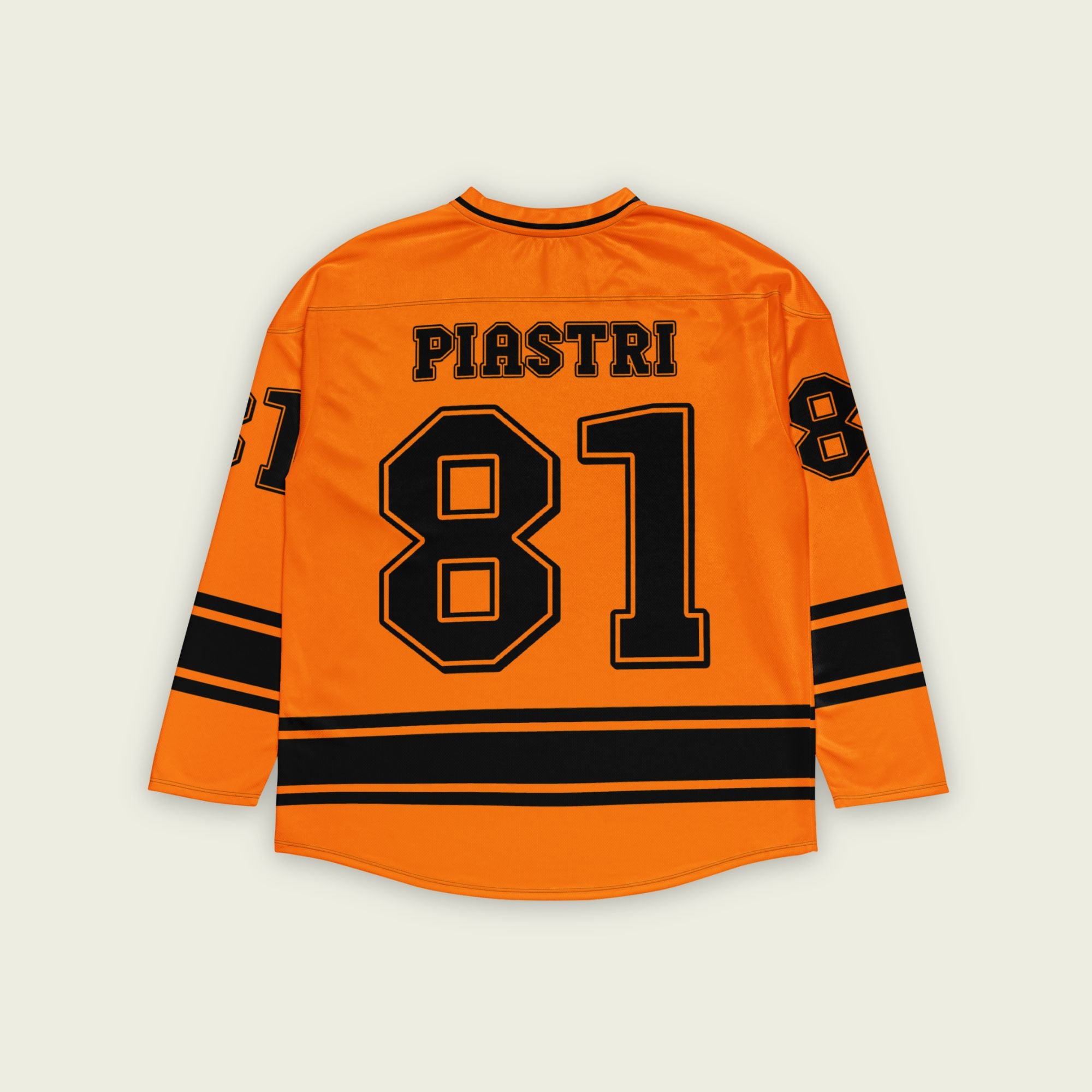 A papaya orange hockey jersey with Oscars piastri's McLaren F1 racing number 81 on the front and back in black, also the name Piastri is on the back in black.