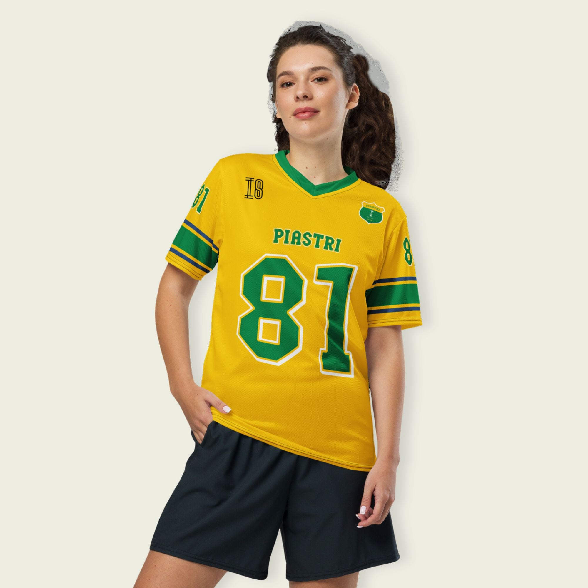 A Aussie green and gold football jersey with Oscar Piastri's McLaren  F1 racing number 81 on the back and front in green with a white outline.