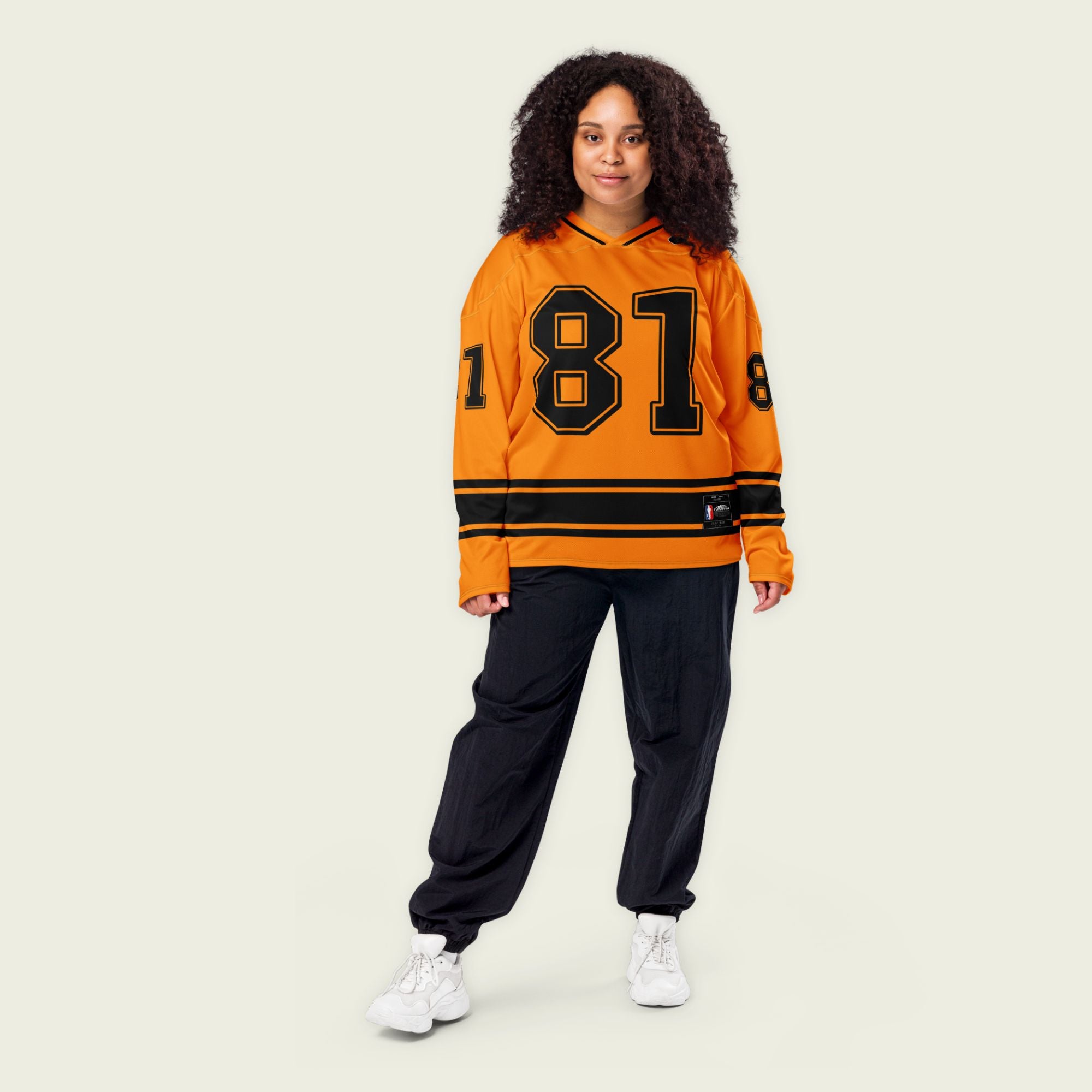 A papaya orange hockey jersey with Oscars piastri's McLaren F1 racing number 81 on the front and back in black, also the name Piastri is on the back in black.