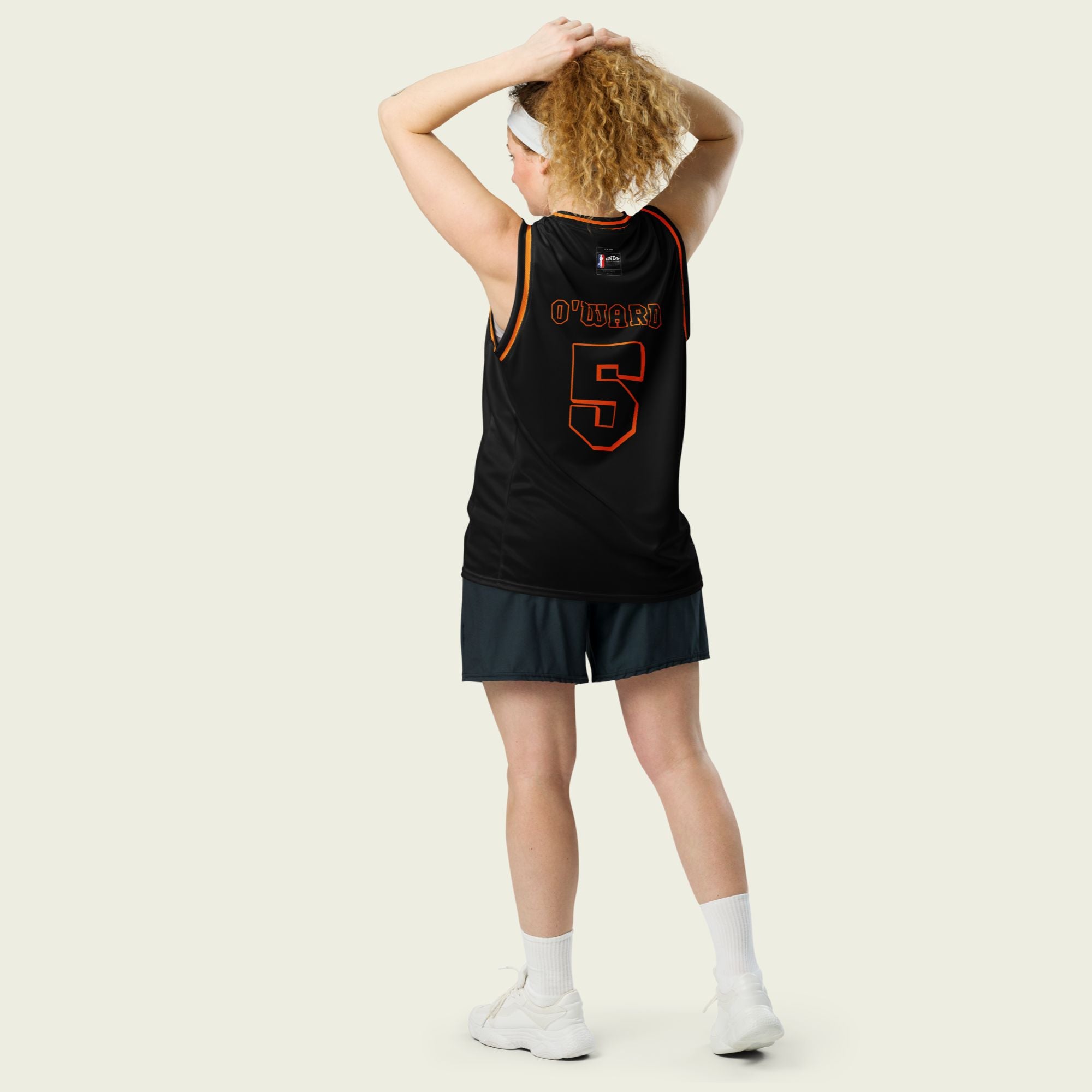 A black and orange outlined basketball Jersey with Pato O'Ward's Arrow McLaren Indycar racing number 5 on the front and back.