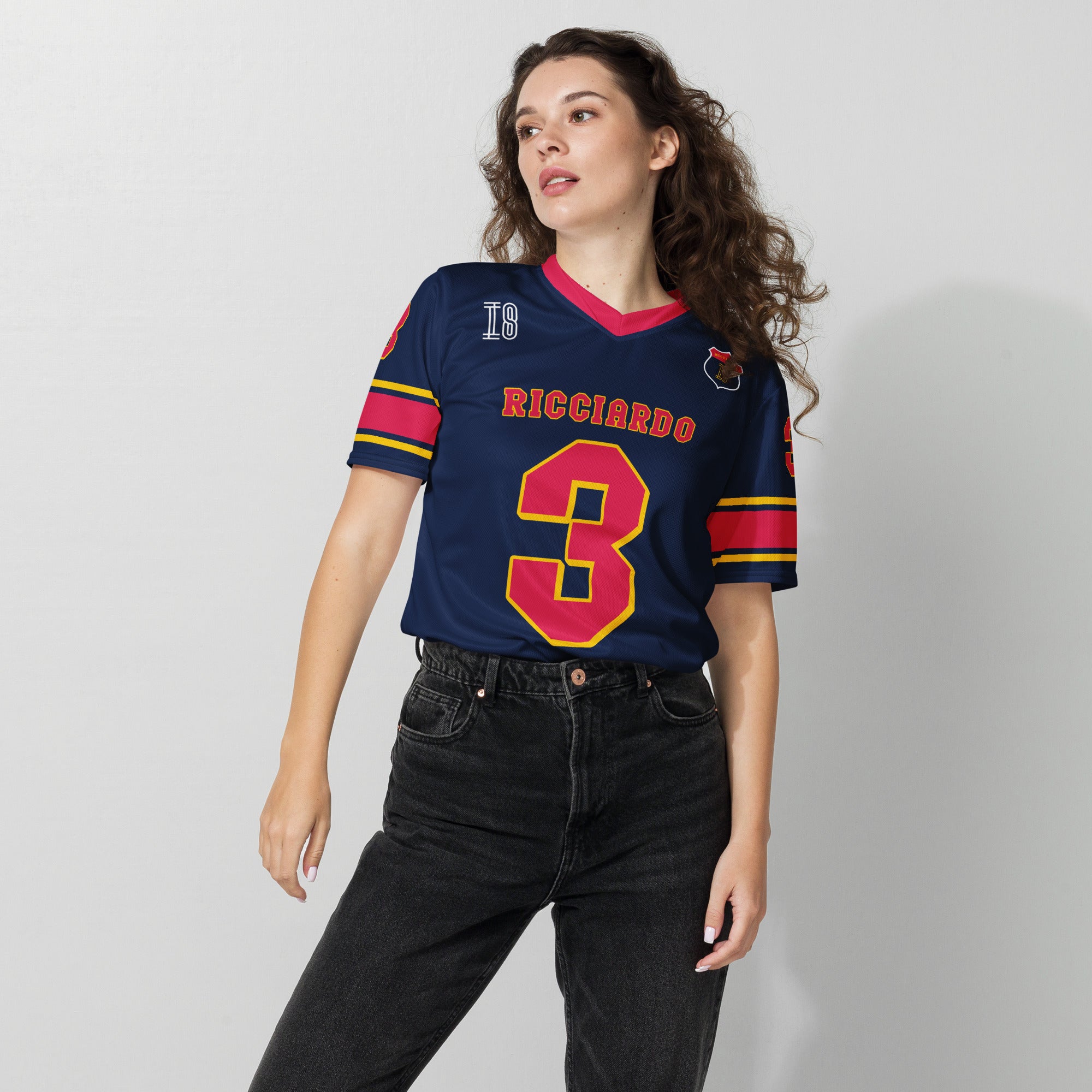 A navy blue and red football jersey with Daniel Ricciardo's Redbull F1 racing number in red on the front and back.