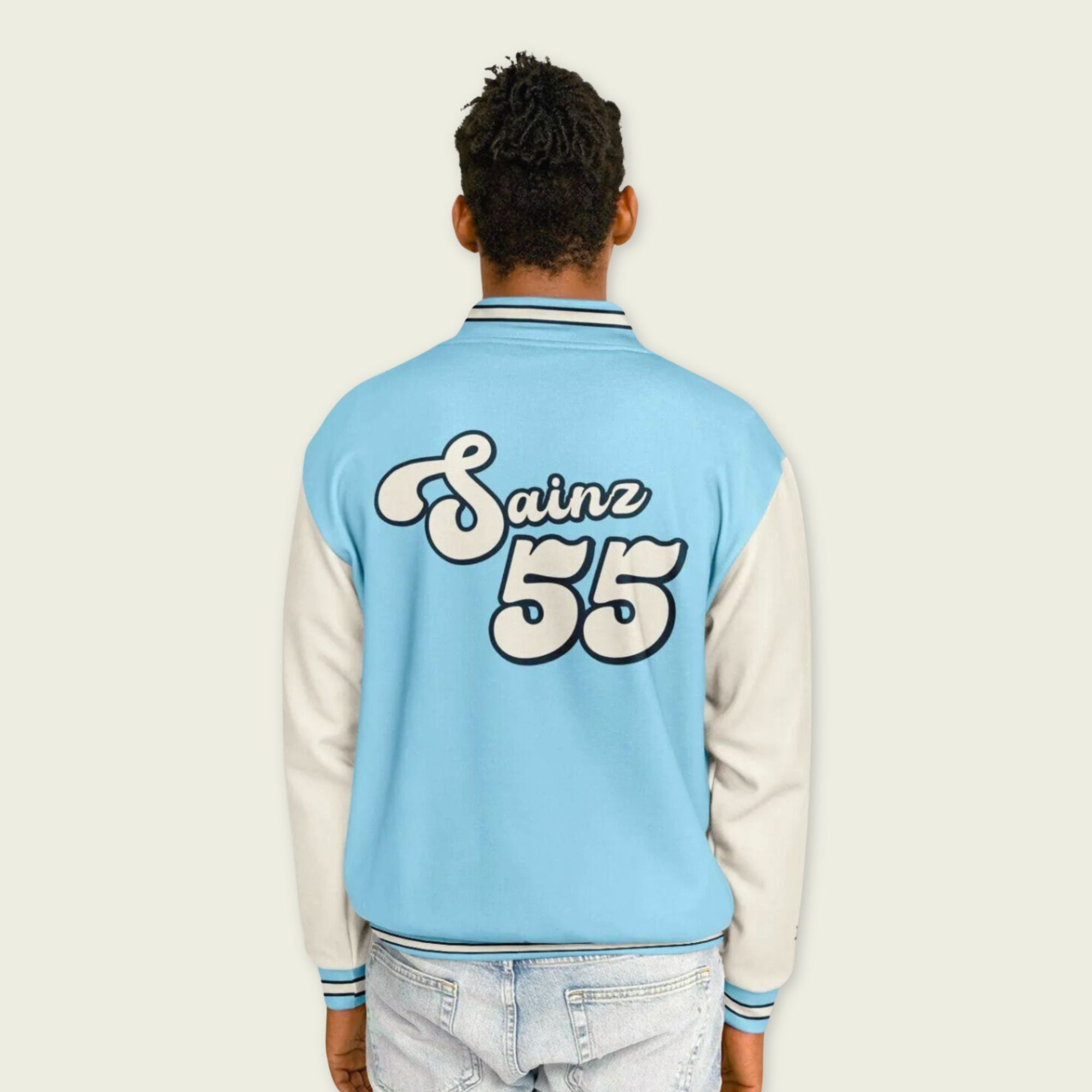 A baby blue and off white varsity jacket with Carlos Sainzs Williams F1 racing number 55 in white on the front and back.