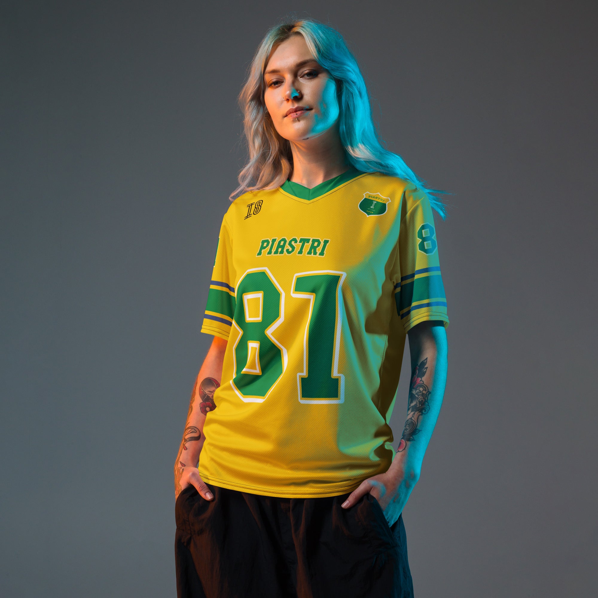 A Aussie green and gold football jersey with Oscar Piastri's McLaren  F1 racing number 81 on the back and front in green with a white outline.